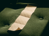 BAMBUM embossed sheets resting on deep green velvet, editorial still